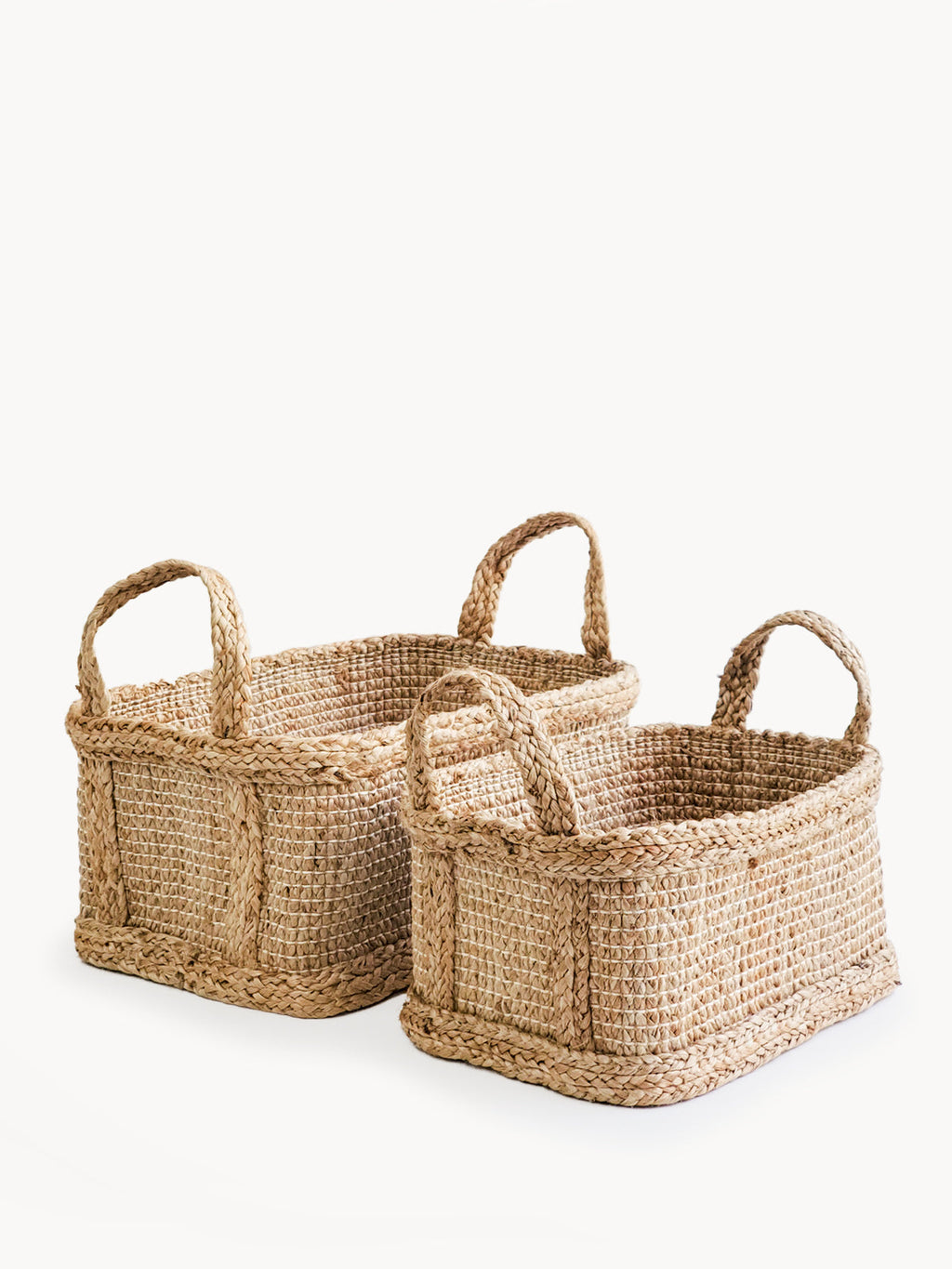Two woven baskets with handles on a white background