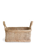 Woven seagrass basket with handles on a white background