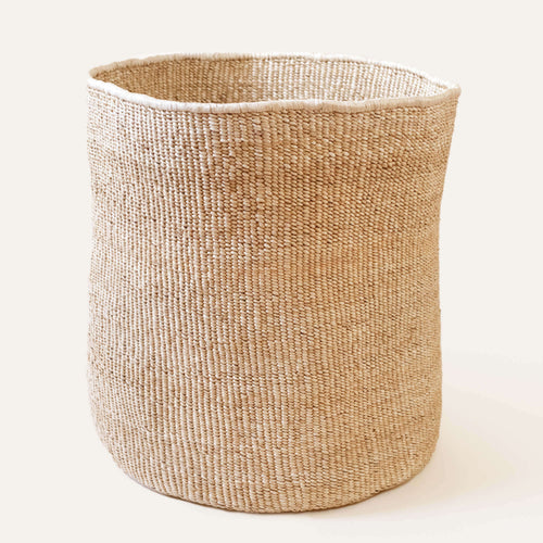 Woven basket made of natural fibers on a white background