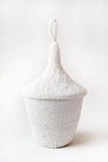 White woven basket with a lid on a white background