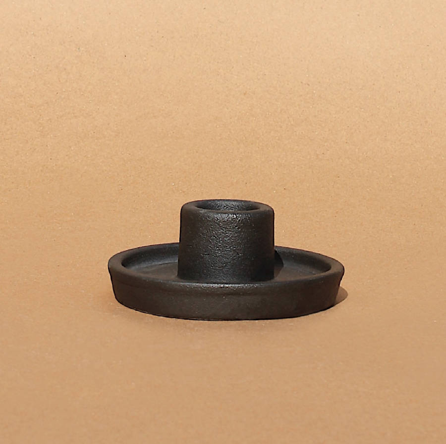 Black metal candle holder on a beige background