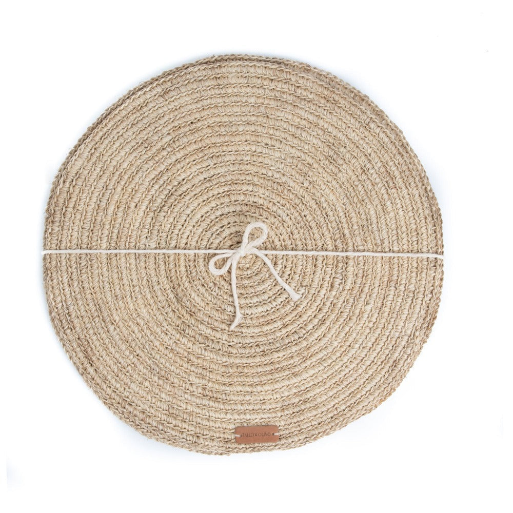 Round woven placemat with a string tie on a white background