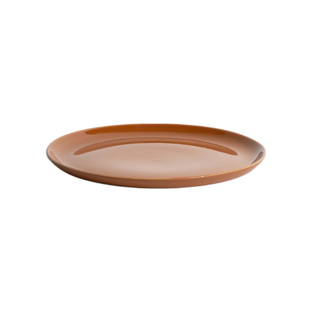 Ceramic plate with a brownish-orange glaze on a white background