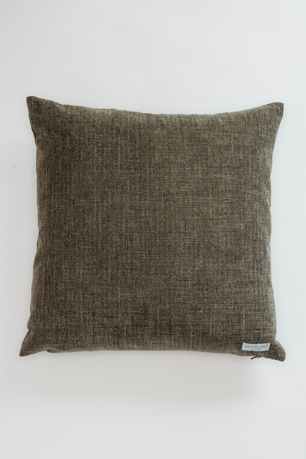 Textured brown pillow on a white background