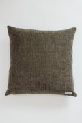 Textured brown pillow on a white background