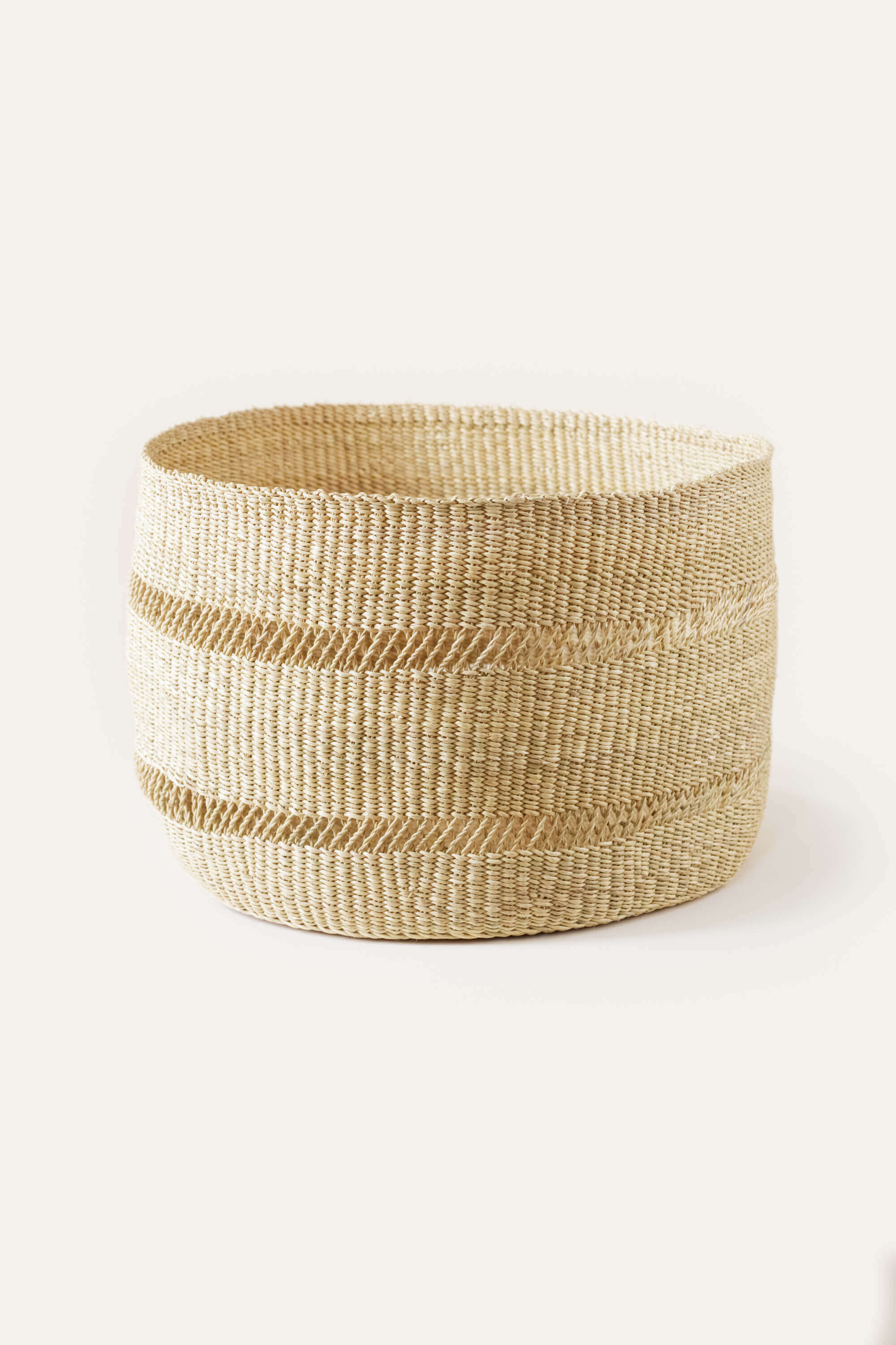 Woven basket with natural fibers on a white background