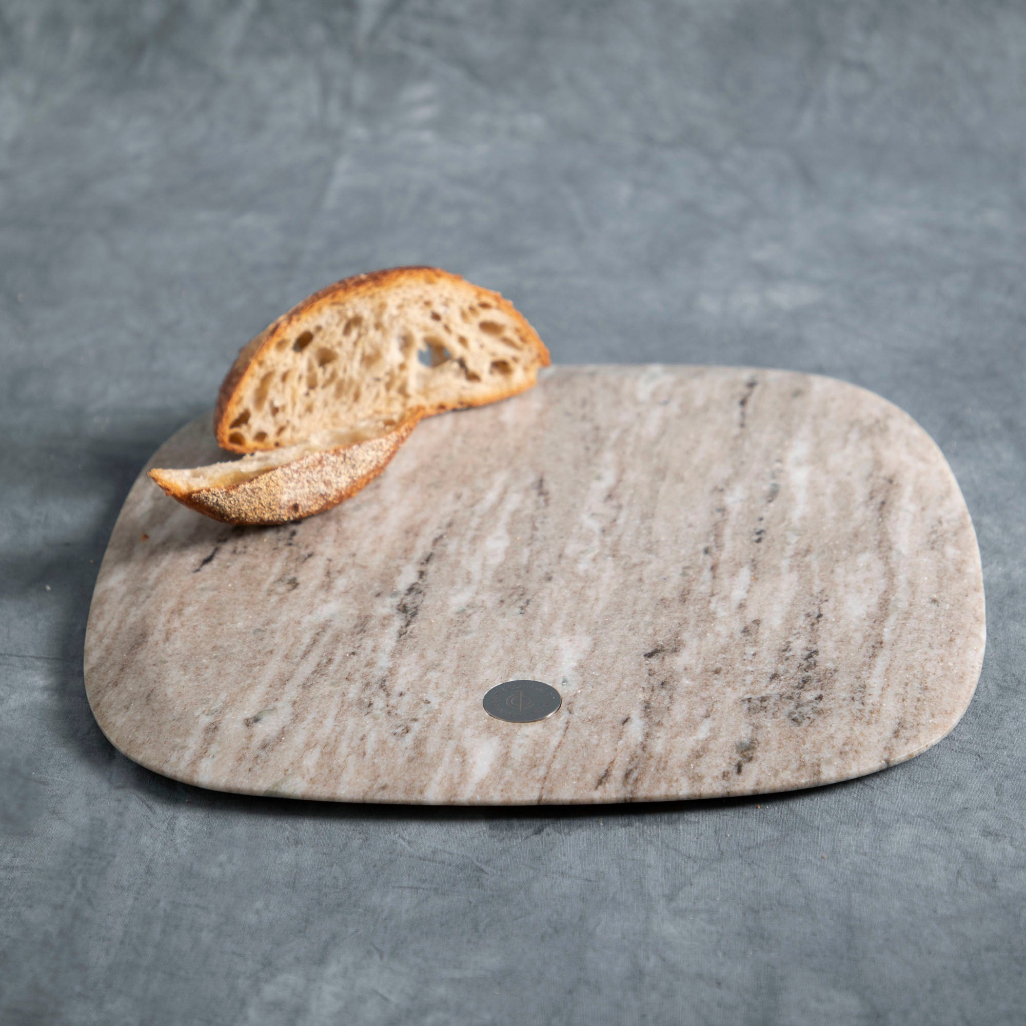 Marble cutting board with a slice of bread on a gray background