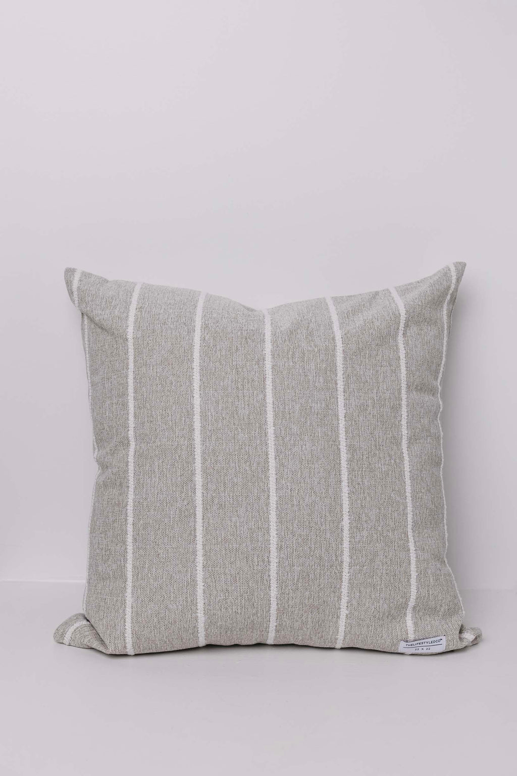 Striped gray pillow on a light gray background