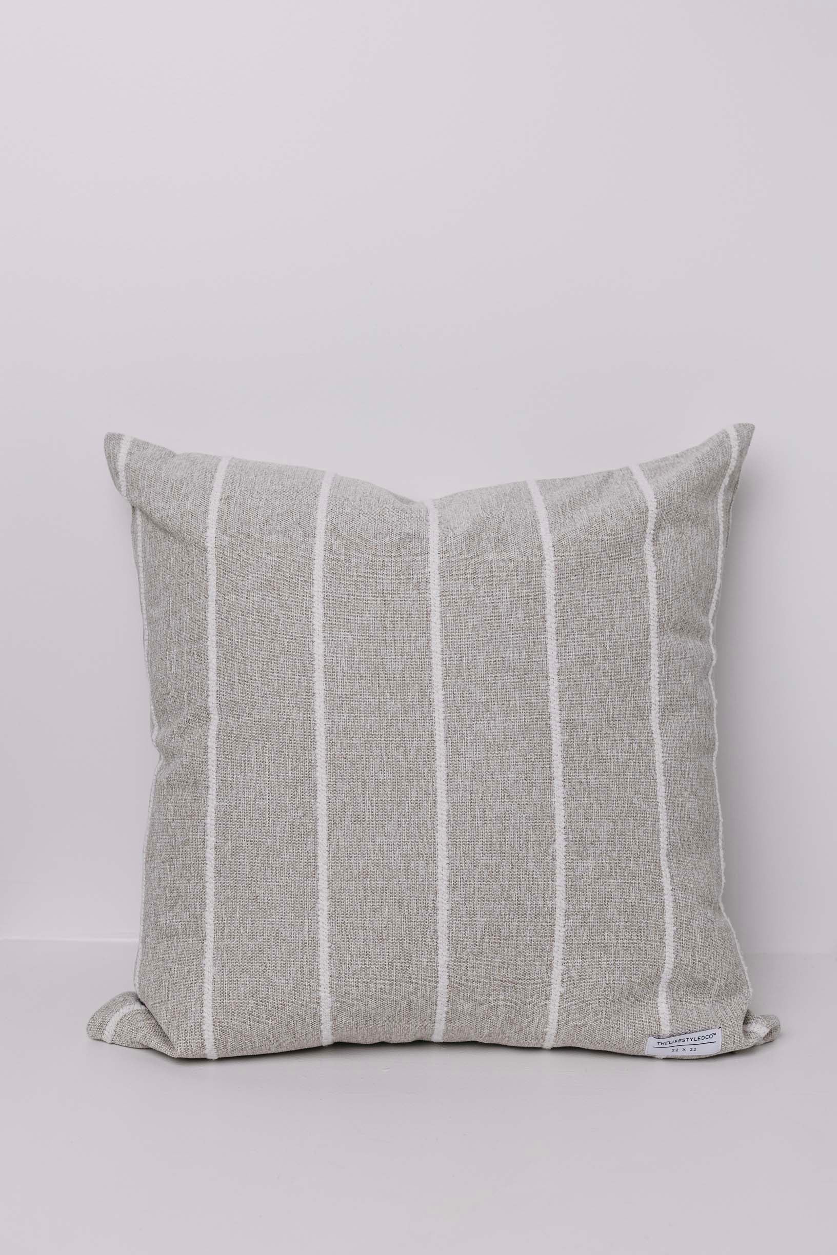 Striped gray pillow on a light gray background