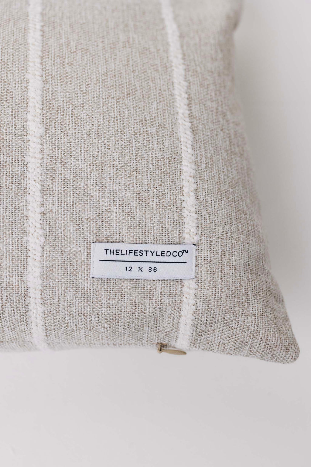 Gray textured pillow with a label on a white background