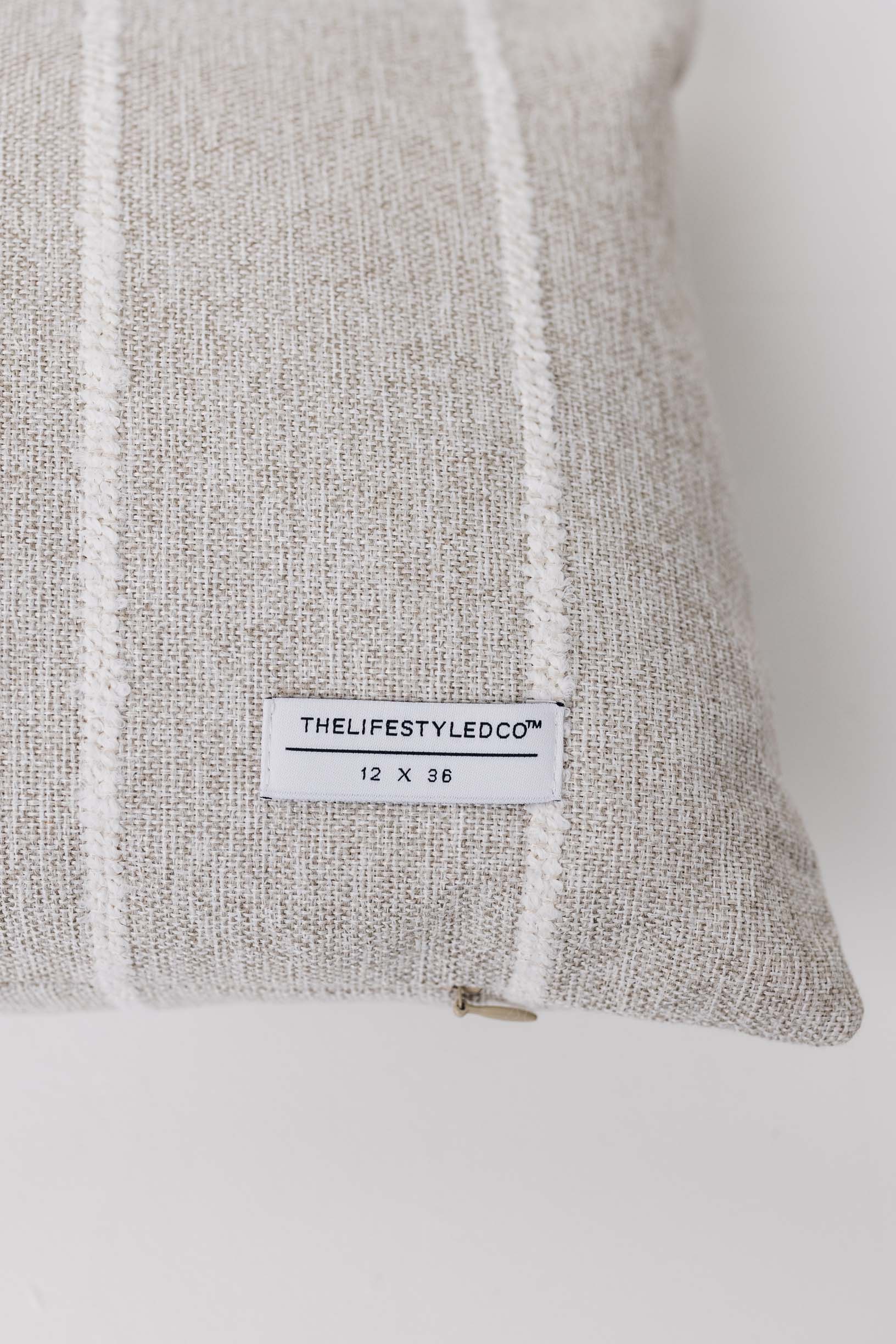 Gray textured pillow with a label on a white background