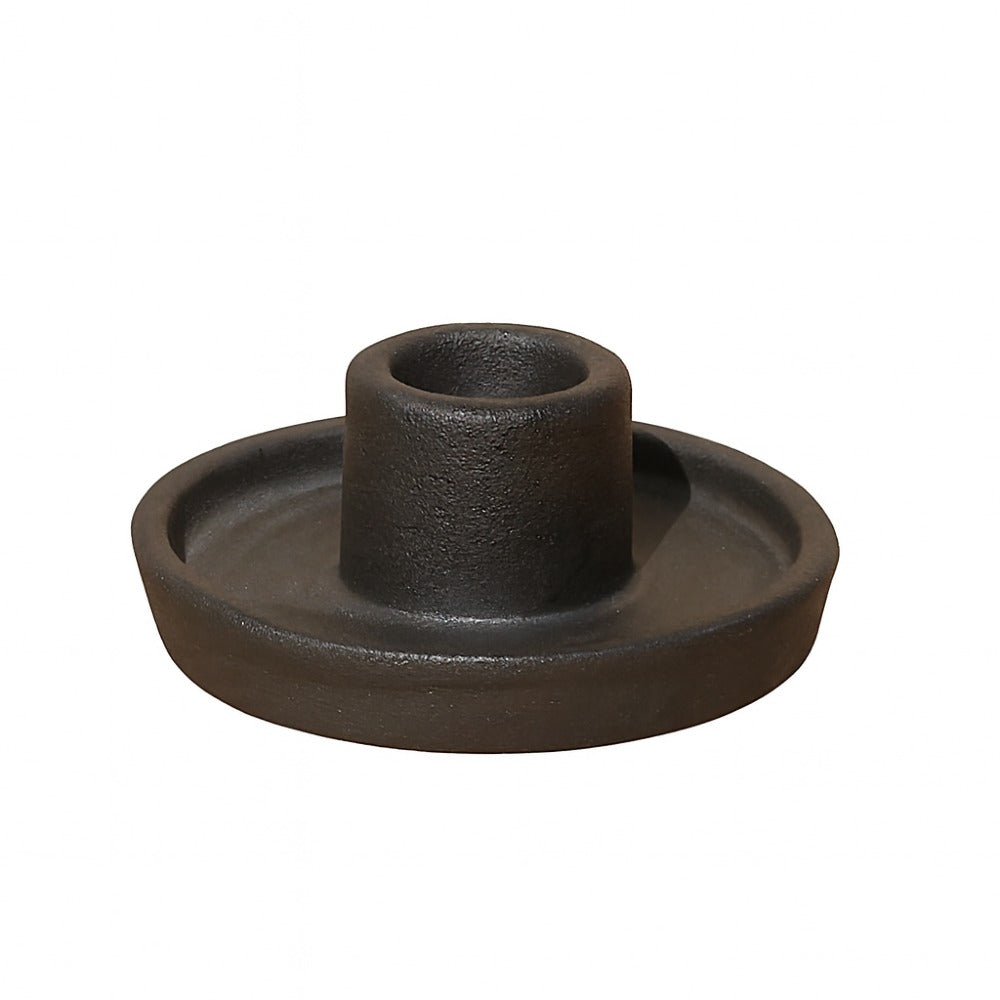 Cast iron candle holder on a white background
