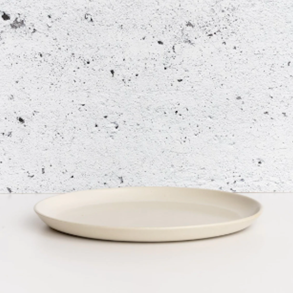 White ceramic plate on a speckled gray background
