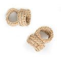 Two beige woven napkin rings on a white background