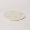 Round marble coaster on a light gray background