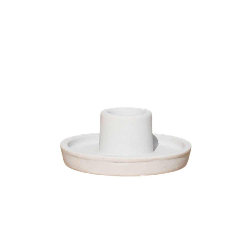 Ceramic candle holder with a white candle on a white background