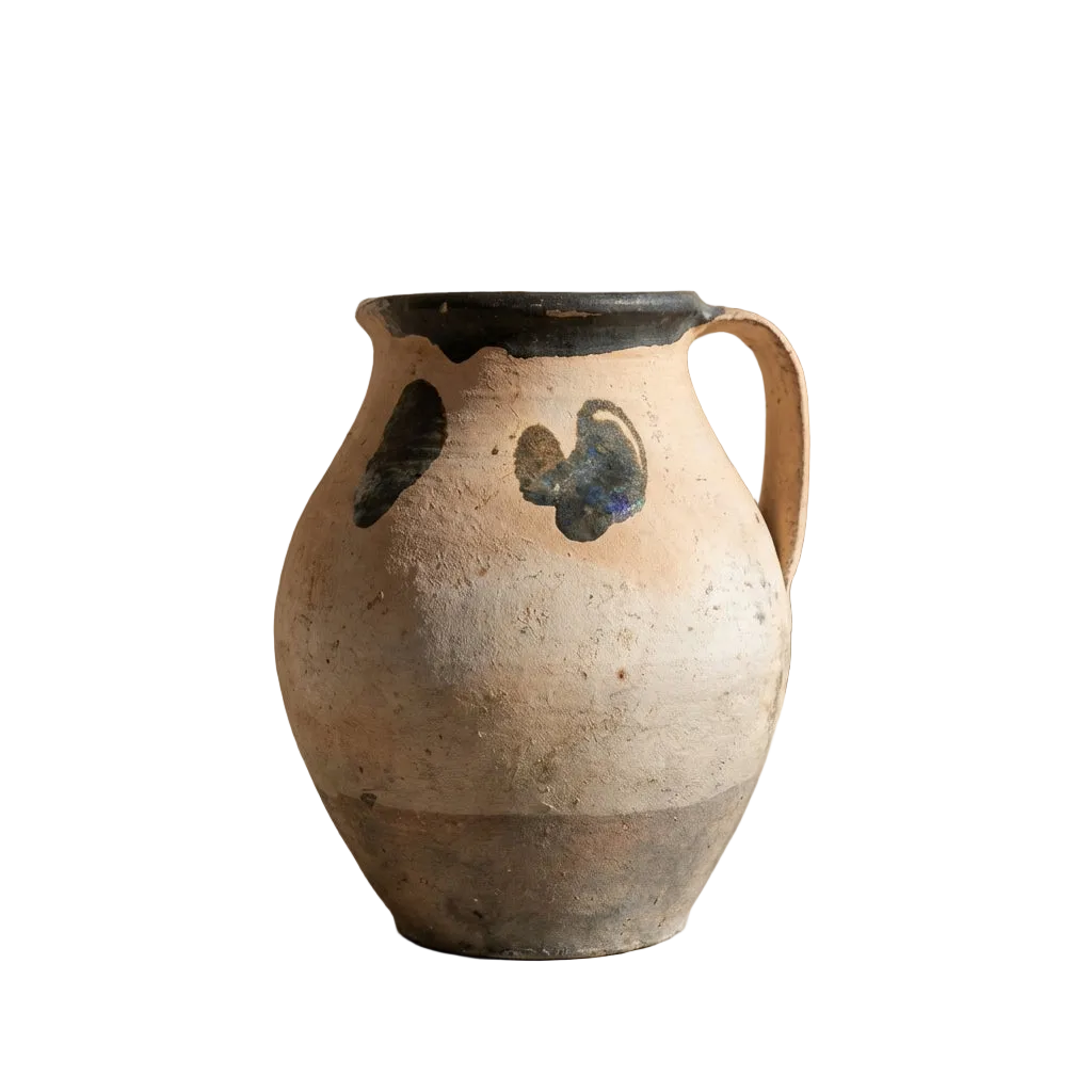 Ceramic pitcher with decorative design on a white background