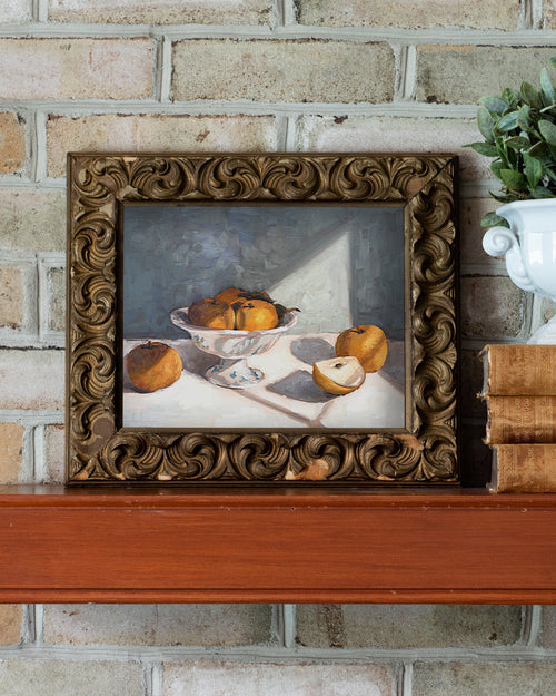 Framed still life painting of apples on a brick wall background