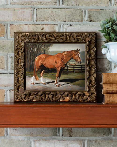 Framed painting of a horse on a brick wall