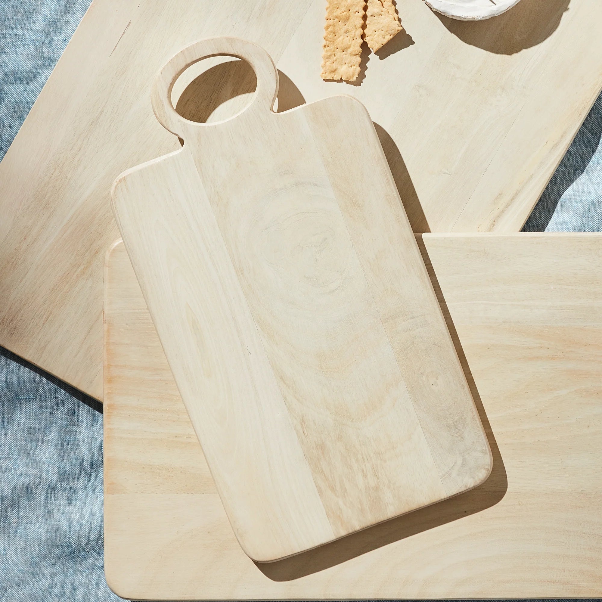 Handcrafted natural wood serving board with a rounded handle and soft organic grain for timeless European-inspired kitchen styling | Sorelle Rossi Shoppe