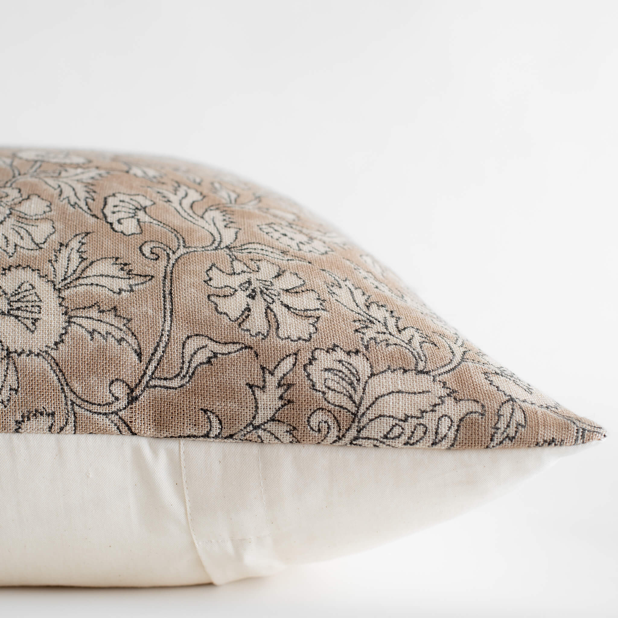 Decorative pillow with floral pattern on a white background