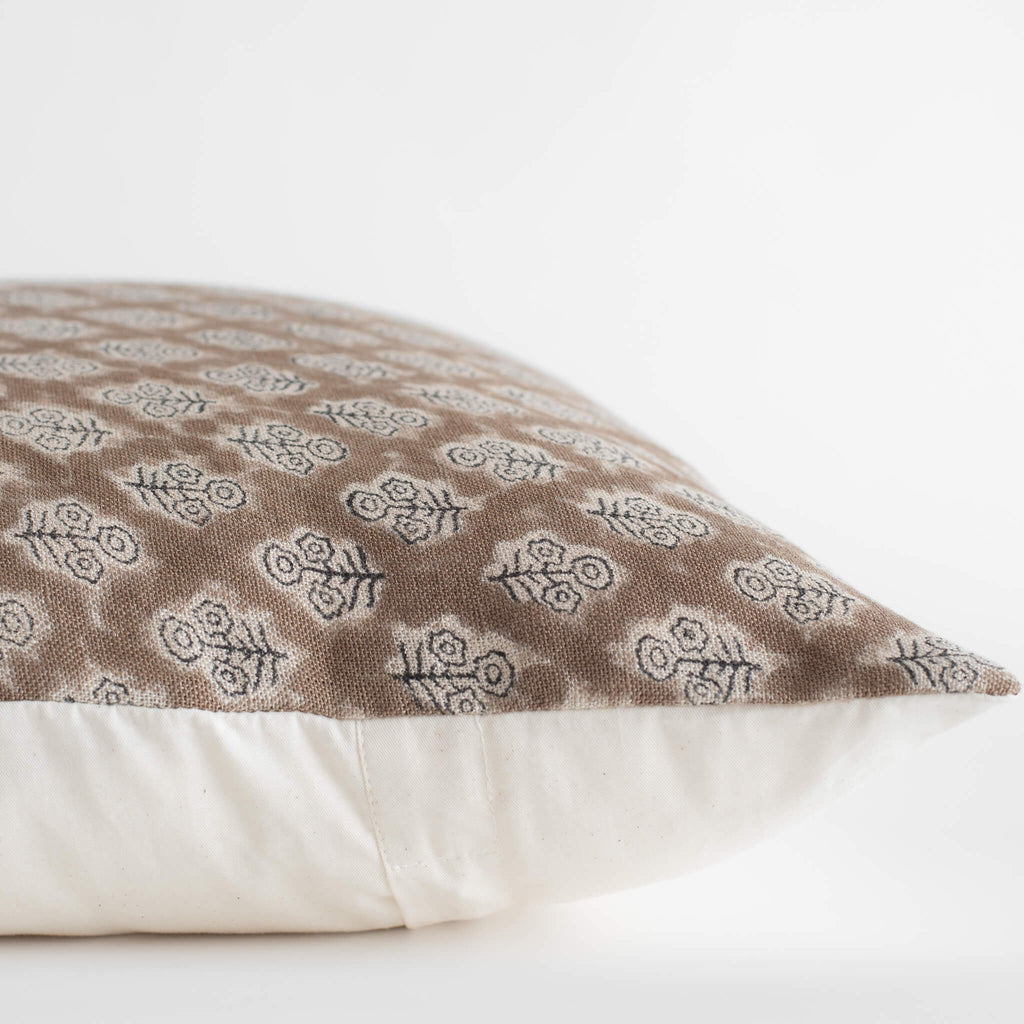 Decorative pillow with a brown and white pattern on a white background