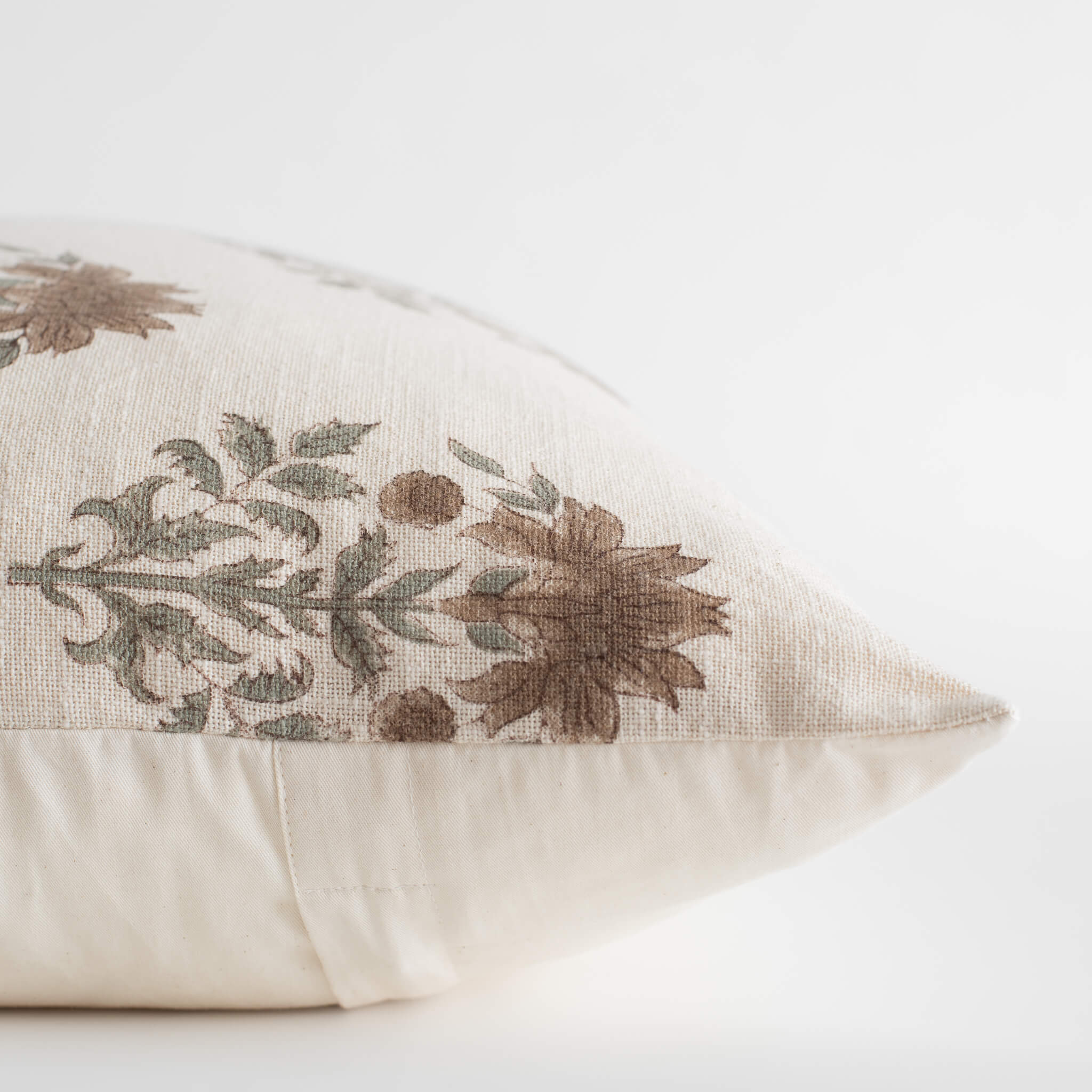 Decorative pillow with floral embroidery on a white background