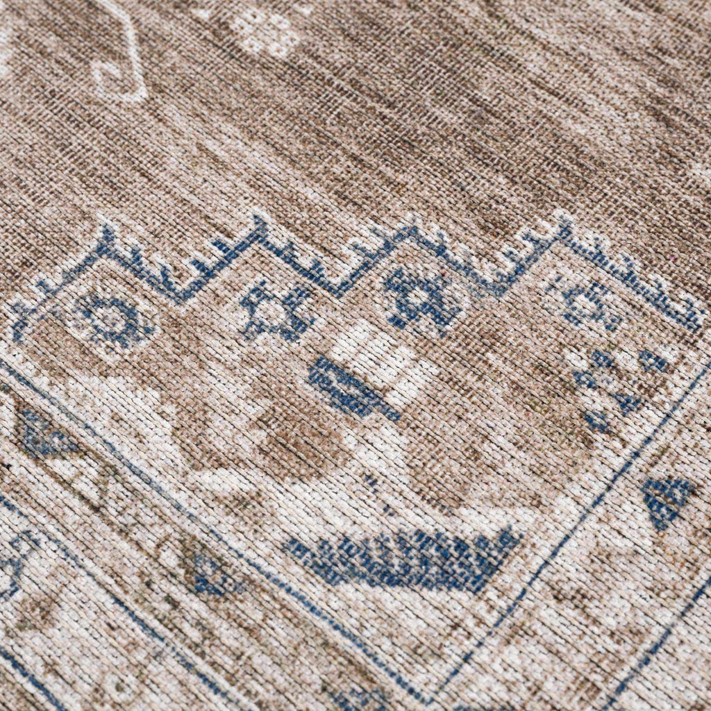 Close-up of a patterned rug with blue and beige colors