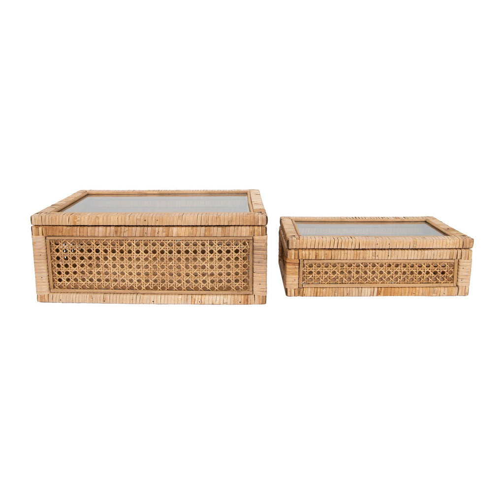 Two woven rattan boxes with glass lids on a white background