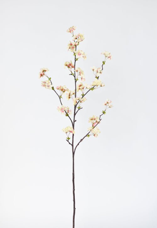 Artificial flower branch with pink and white flowers on a light gray background