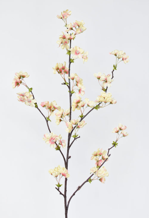 Artificial cherry blossom branch with pink and white flowers on a light gray background