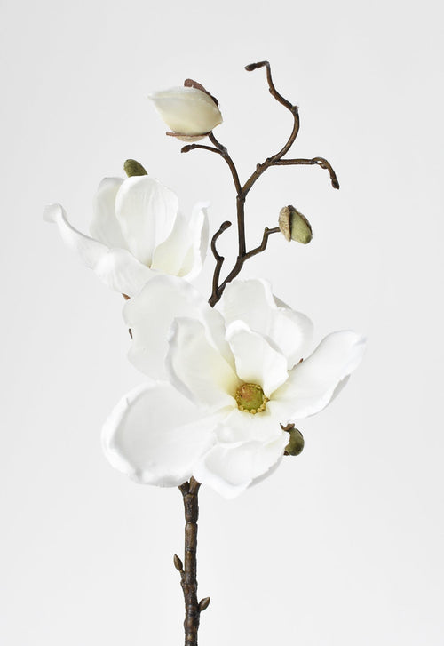 Artificial white flower branch on a light gray background