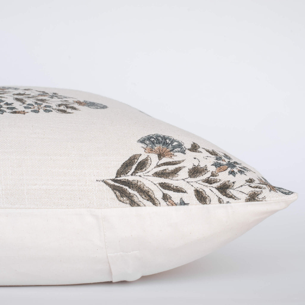 Decorative pillow with floral embroidery on a light background