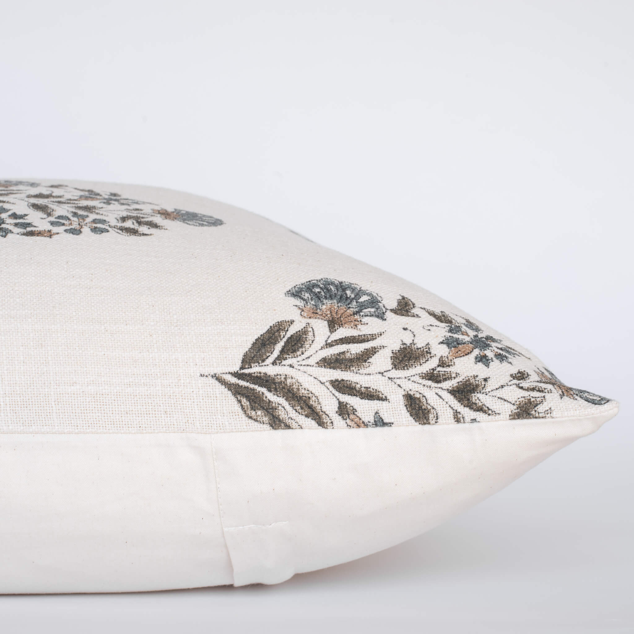 Decorative pillow with floral embroidery on a light background