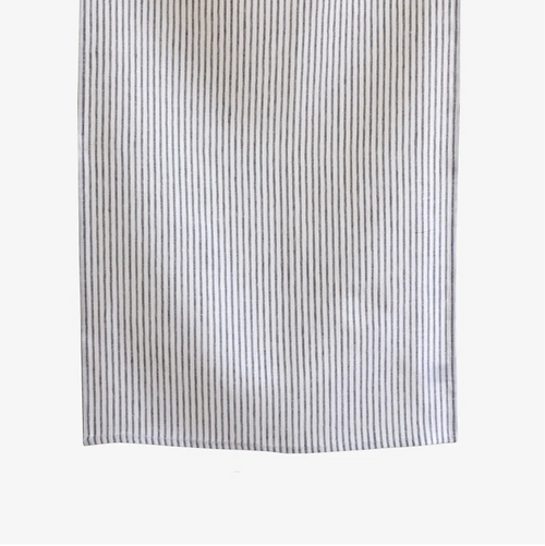 Striped towel hanging on a clothesline against a white background