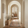 European-inspired hallway interior – warm neutral tones and arched architectural details – timeless luxury home styling | Sorelle Rossi Shoppe
