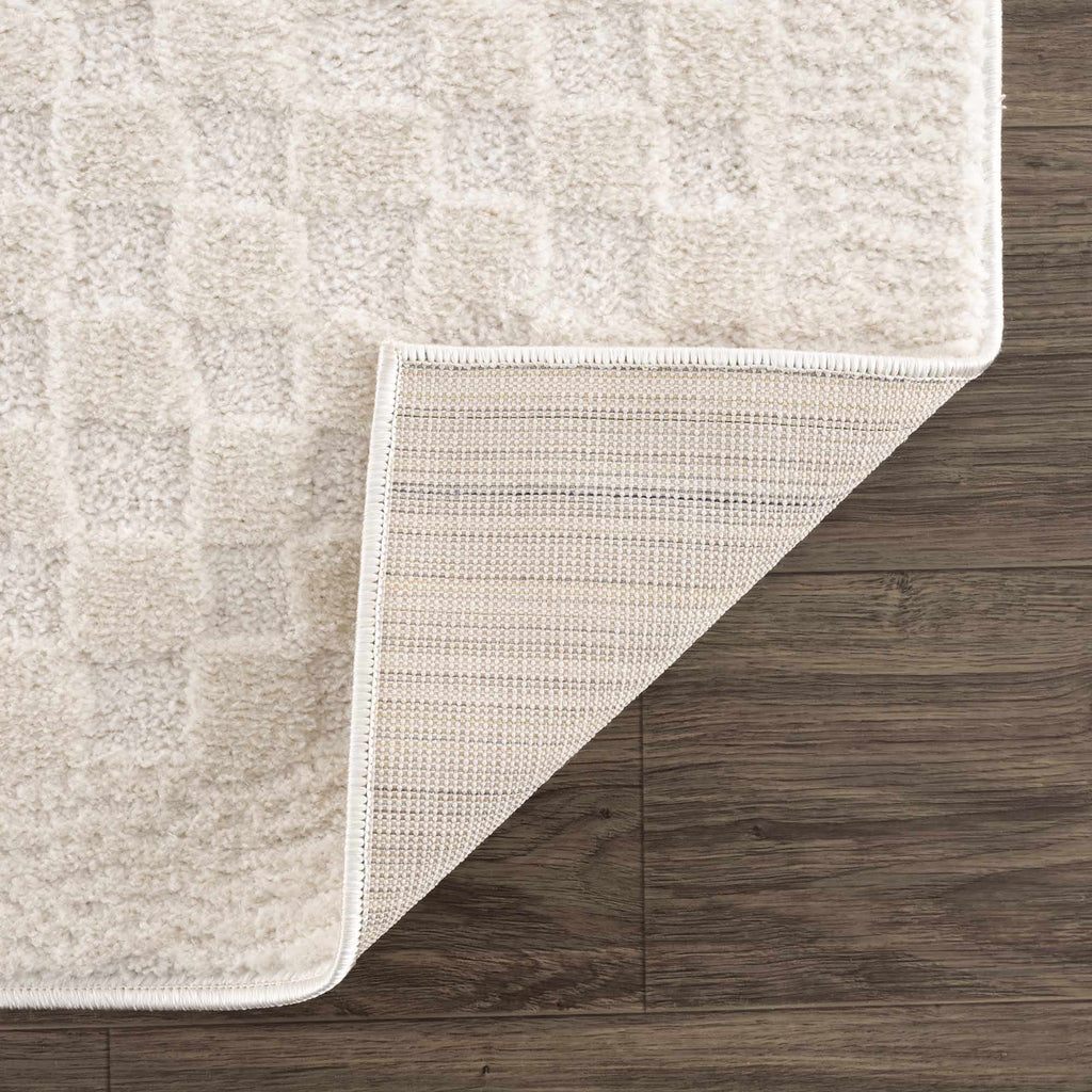 Beige rug corner on a wooden floor