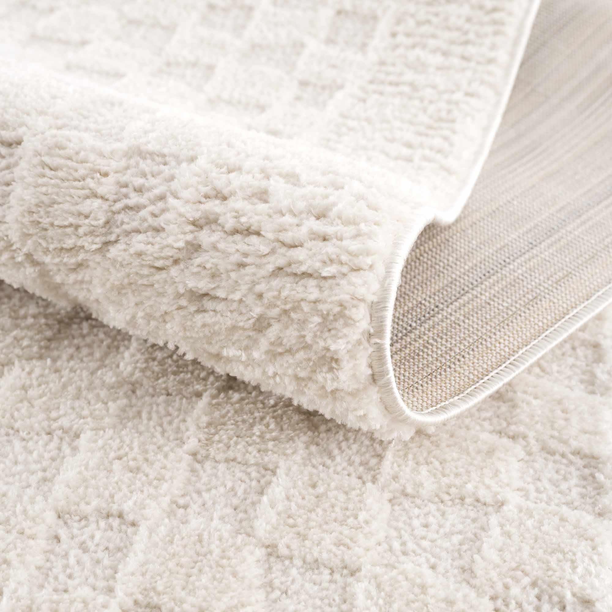 Close-up of a beige textured fabric surface
