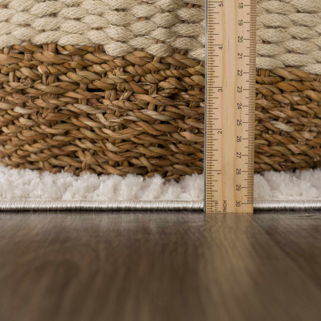 Rug with a woven texture and a ruler for scale on a wooden floor.