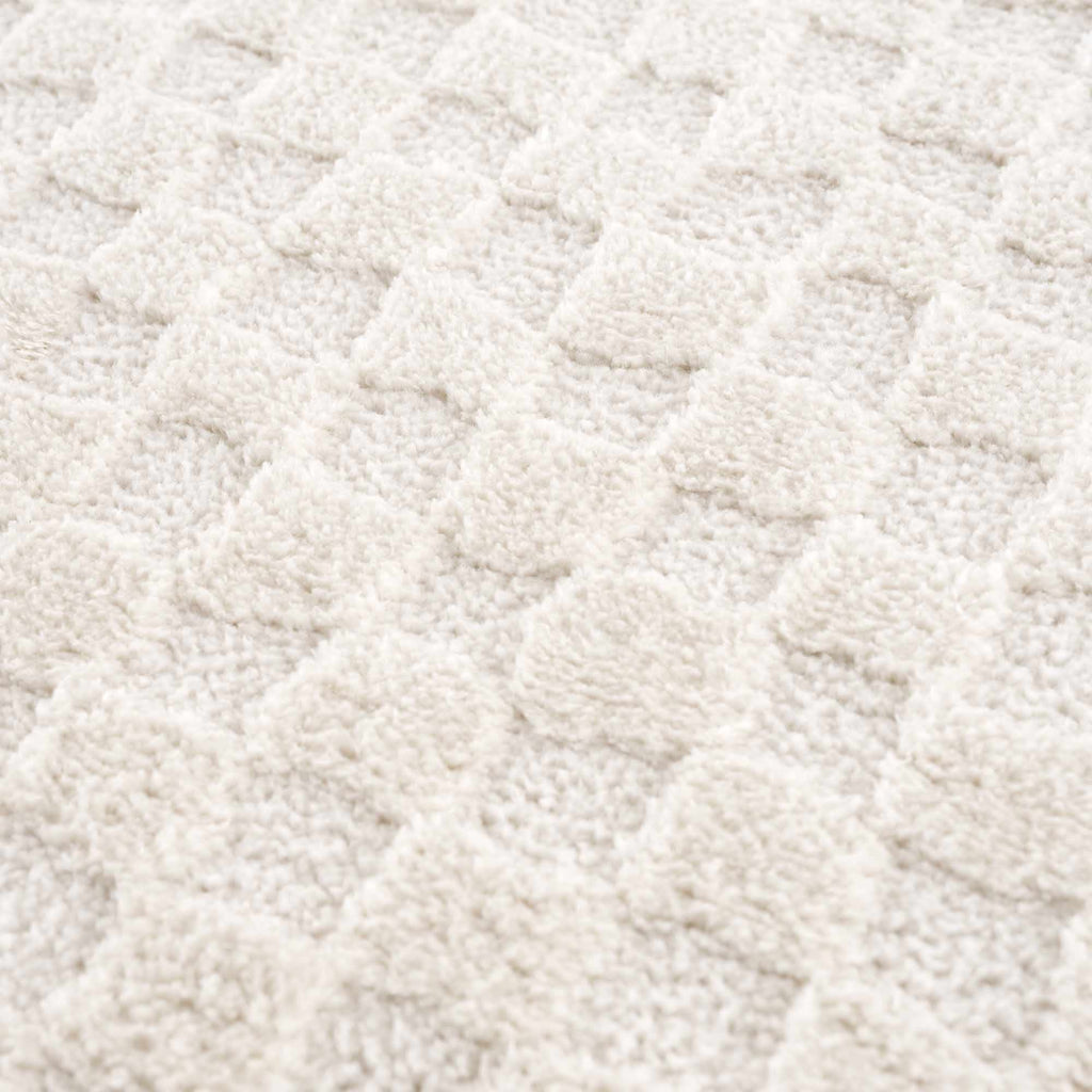 Close-up of a textured beige fabric surface