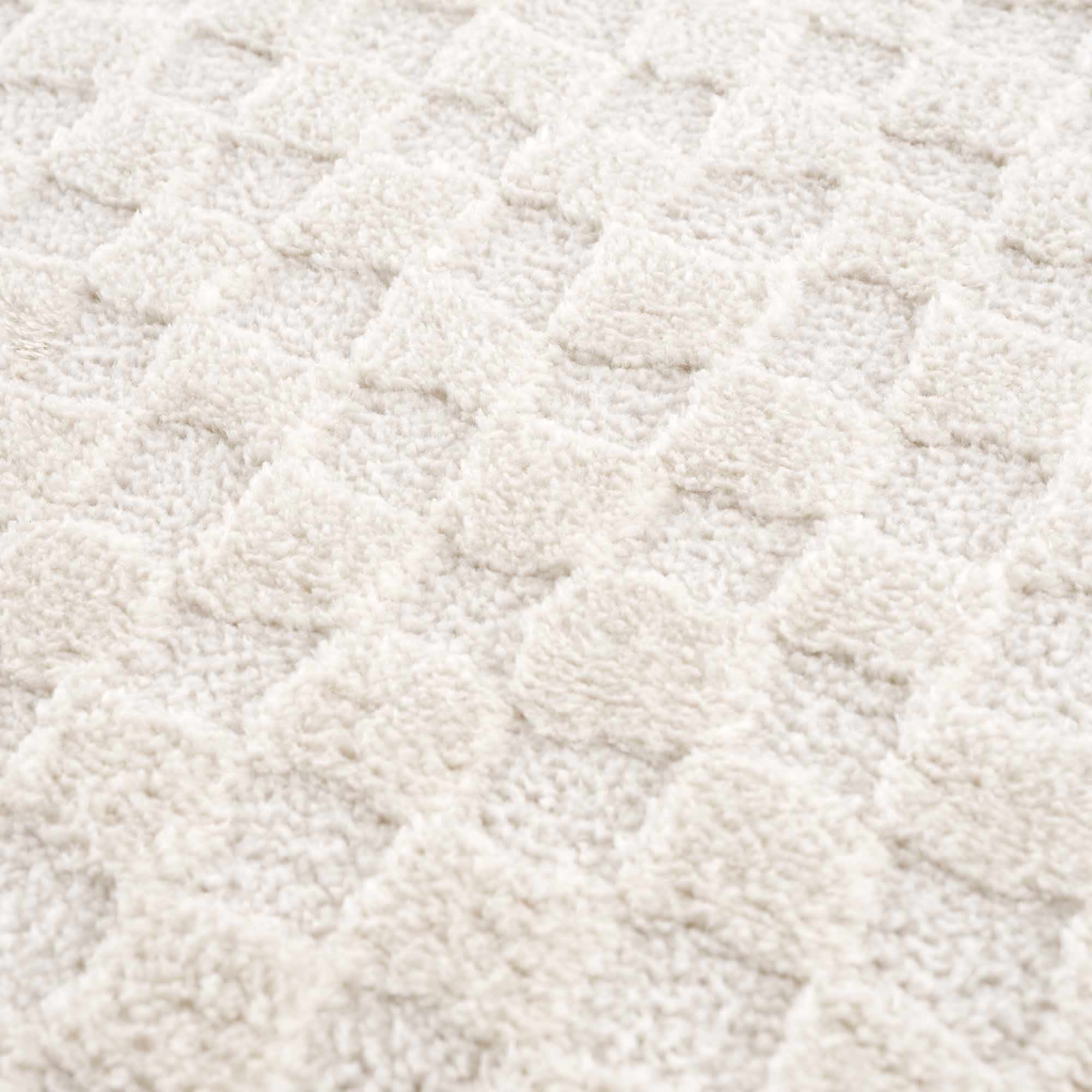 Close-up of a textured beige fabric surface
