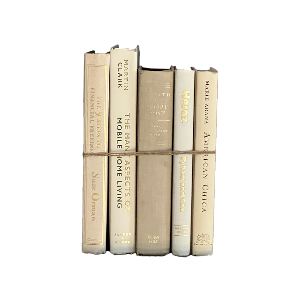 Stack of books with gold and beige spines on a white background