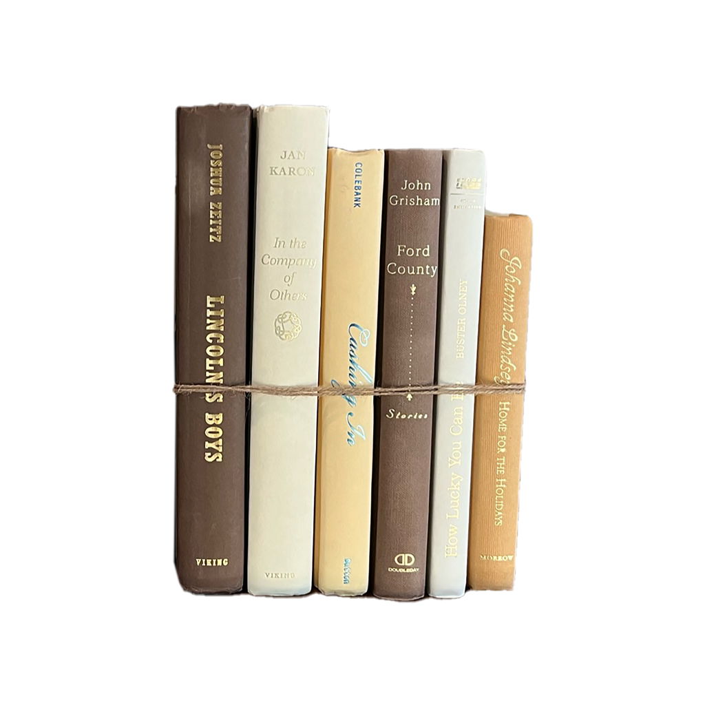 Stack of books tied together with a string on a white background