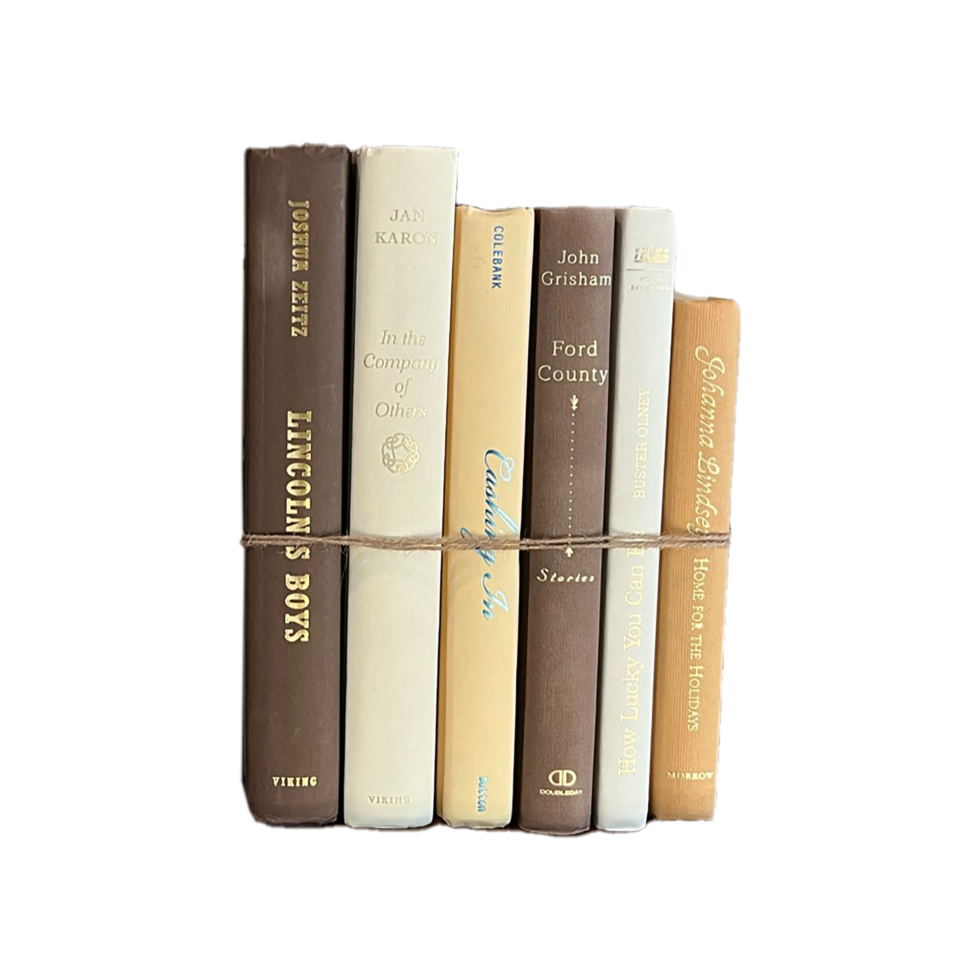 Stack of books tied together with a string on a white background