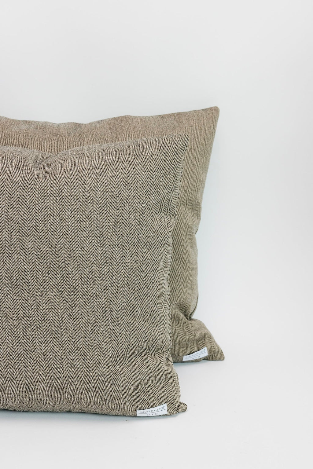 Two brown textured pillows on a white background