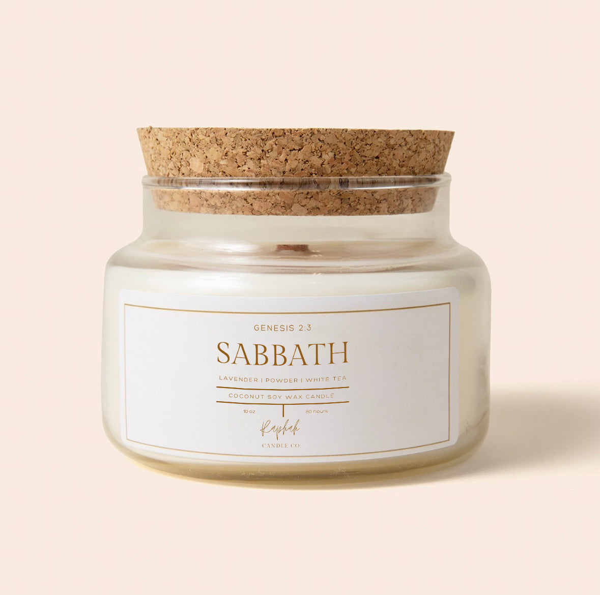 Candle jar with cork lid and 'Sabbath' label on a beige background