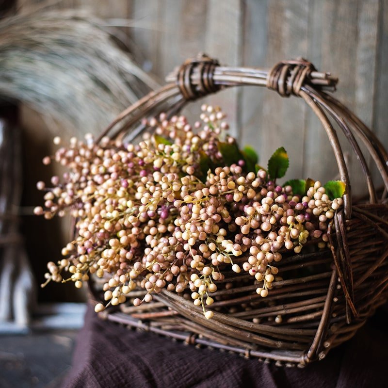 Wicker basket with dried flowers against a blurred background