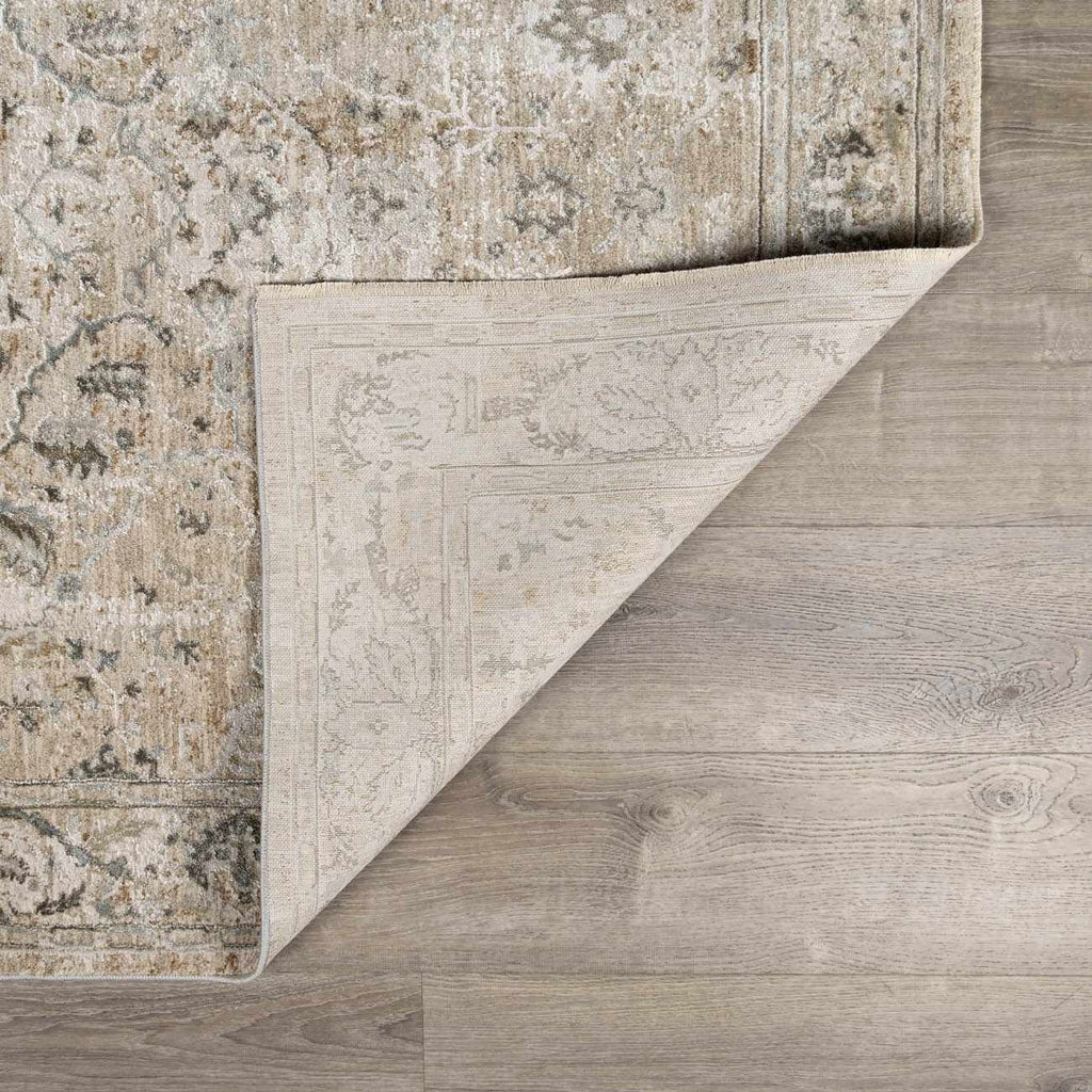 Close-up of a rug with a textured pattern on a wooden floor.
