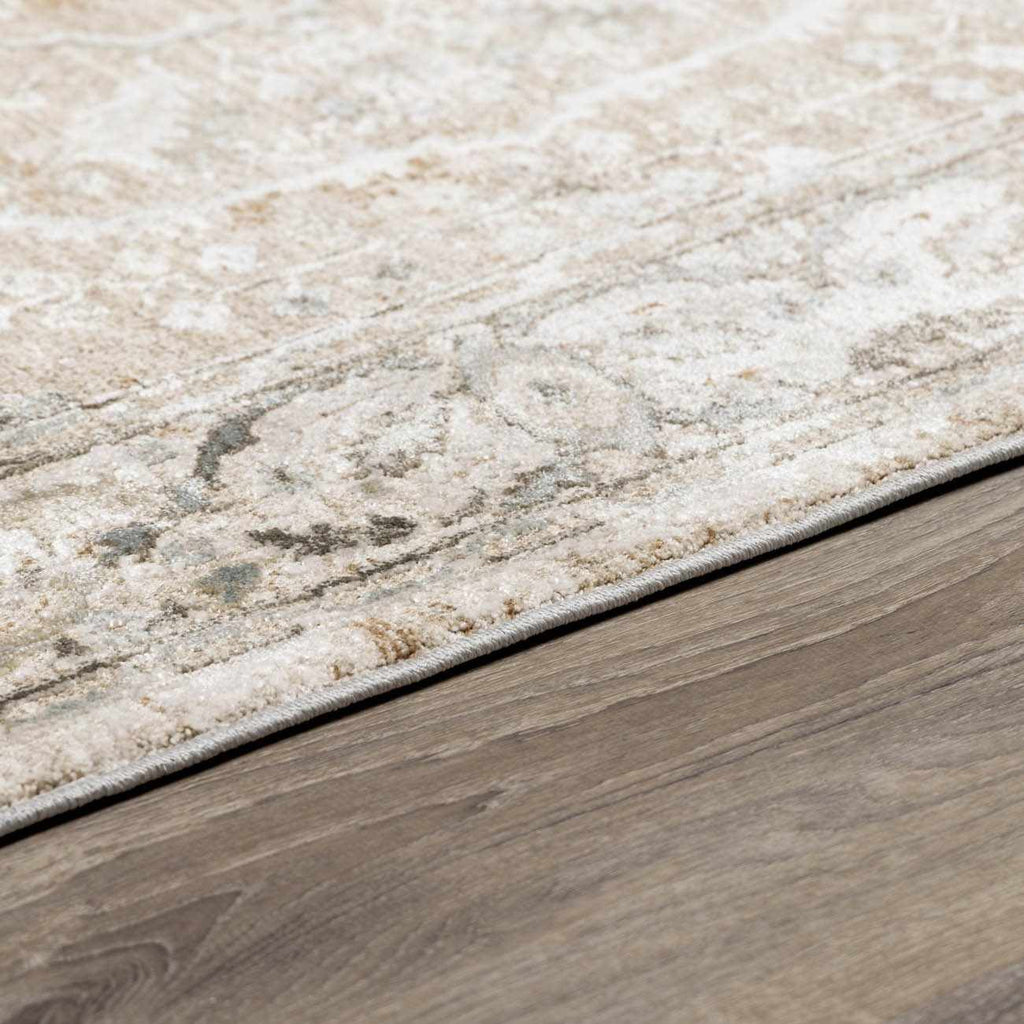 Close-up of a textured rug transitioning to a wooden floor.