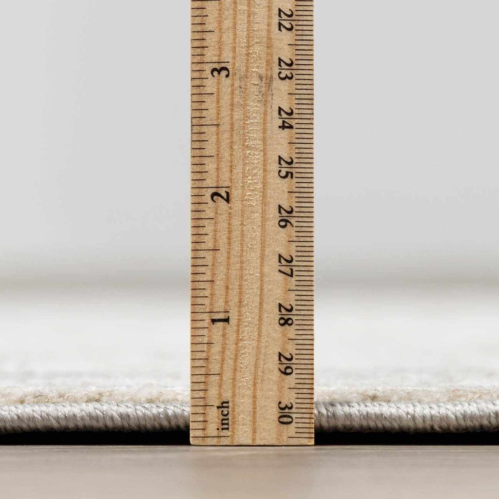 Wooden ruler on a carpet with a neutral background